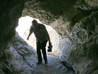 Author hiking in the mud caves