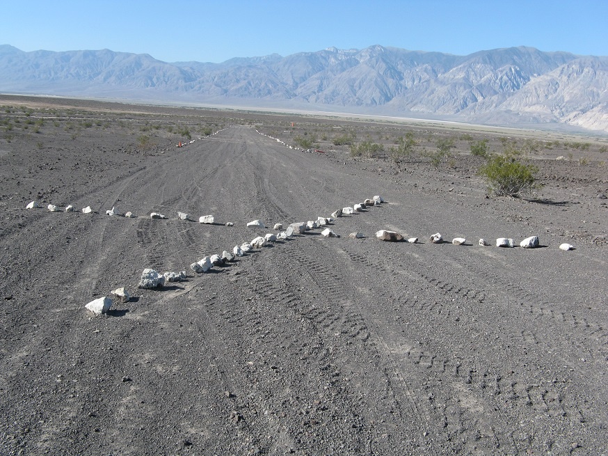 A large X constructed out of white stones signals to pilots that the Chicken Strip is unsafe and closed. NPS photo by "Lizard" Lee Greenwell