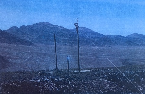 Three power poles burned after being struck by lightning. This complex of three power poles was struck by lightning and burned, stopping electrical supply to Death Valley.