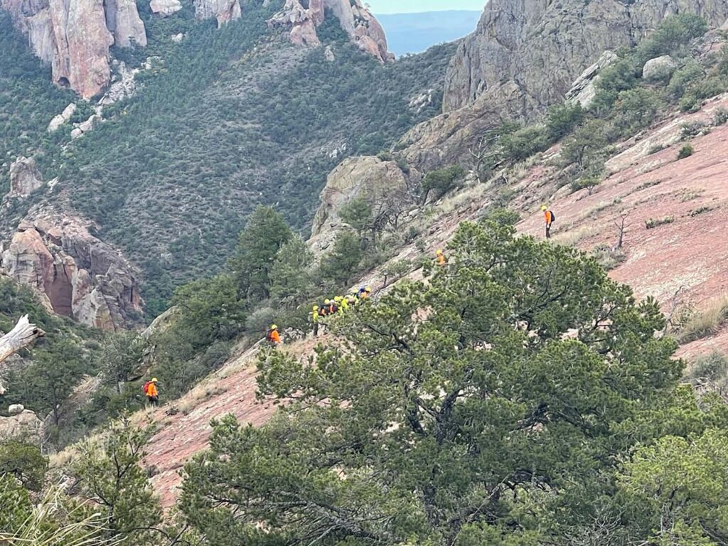 Rescuers negotiating steep terrain with the patient.
TX Department of Public Safety