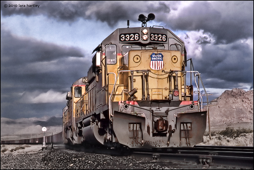 Dramatic clouds and a low angle add some interest to this wedgie shot of a Union Pacific Railway train sitting outside of Nipton, Calif. in the far Eastern Mojave Desert.